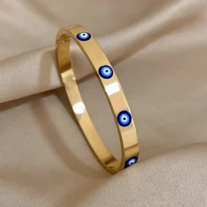 Gold-tone stainless-steel cuff bracelet with dripping design and Evil Eye symbol, Alkimia Charms jewelry